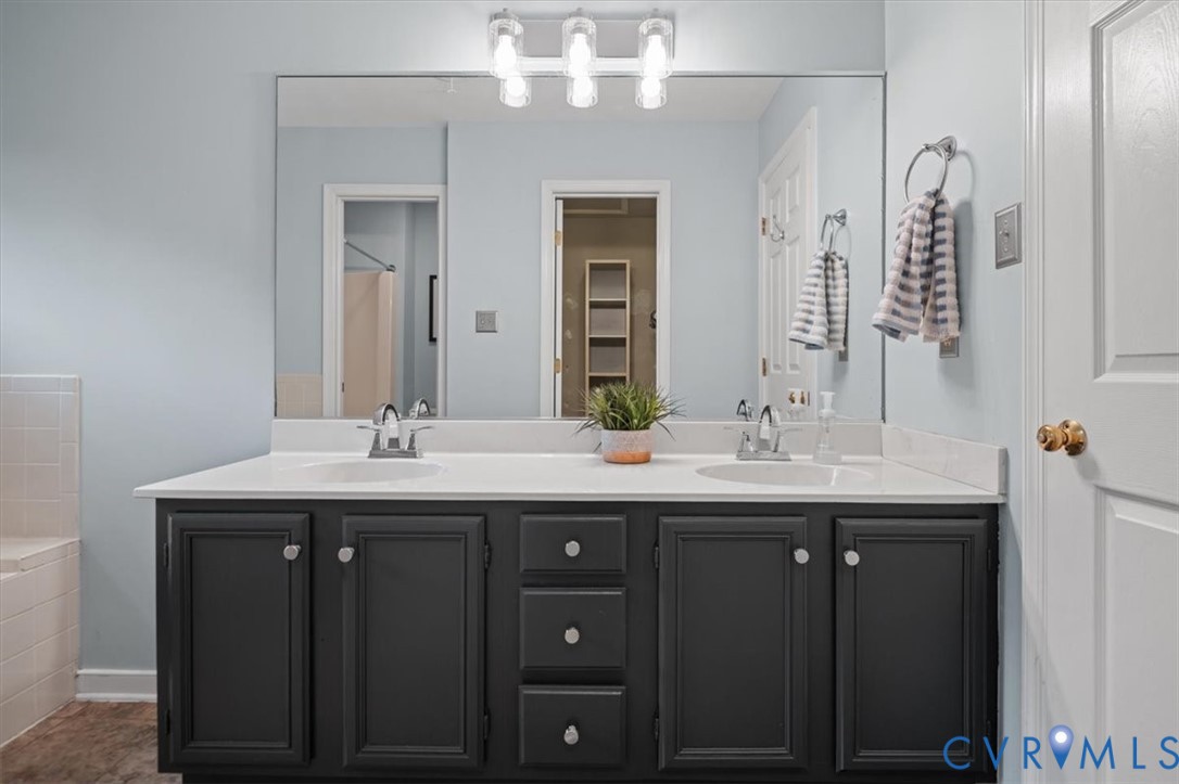 5506 Windy Ridge Terrace Midlothian, VA 23112 - Photo 32 of 50 a bathroom with a granite countertop sink a large mirror and a