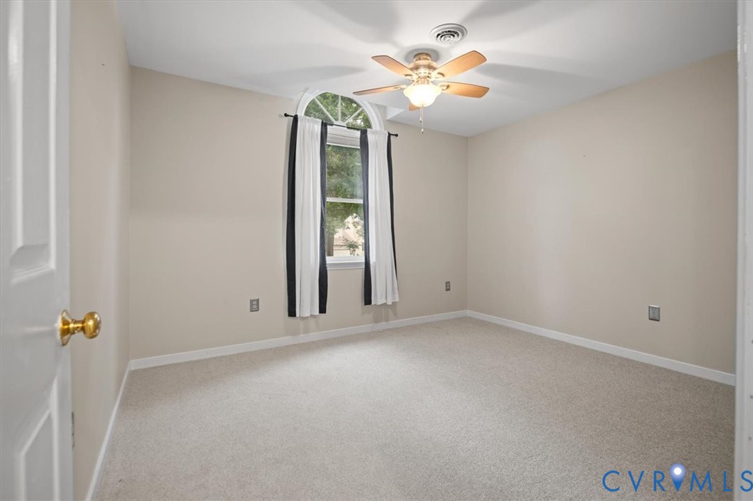 5506 Windy Ridge Terrace Midlothian, VA 23112 - Photo 39 of 50 an empty room with windows and chandelier fan
