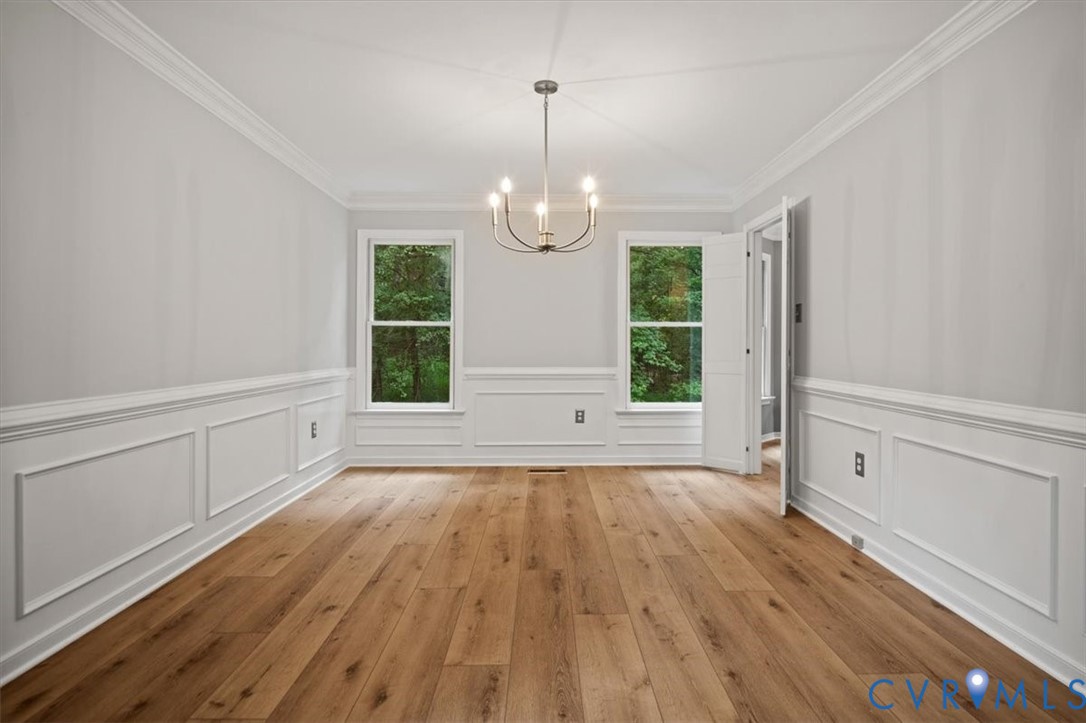 5506 Windy Ridge Terrace Midlothian, VA 23112 - Photo 9 of 50 a view of an empty room with wooden floor and a window