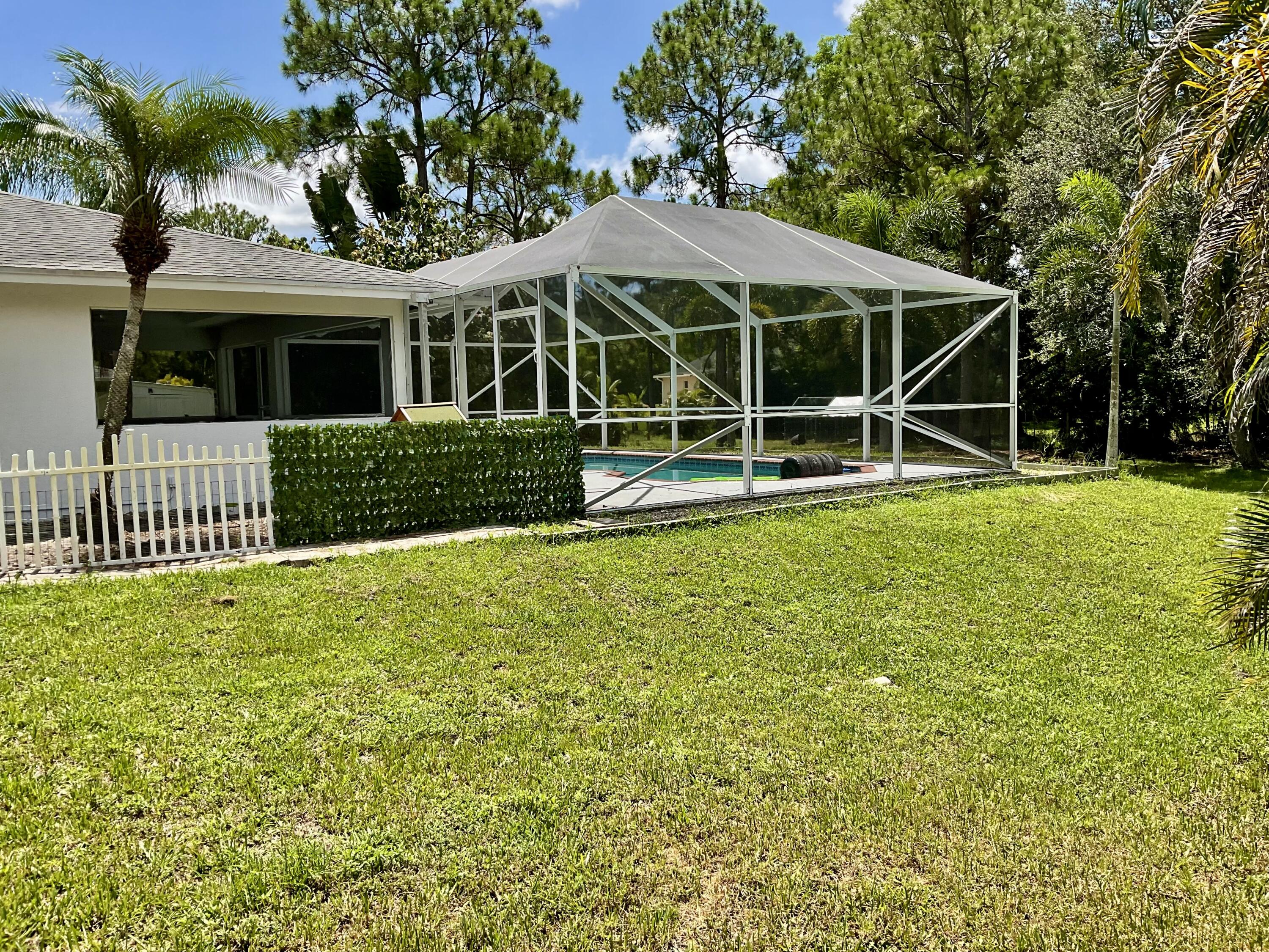 14718 85th Road North Loxahatchee, FL 33470 - Photo 28 of 45 Screened Patio / Side Garden