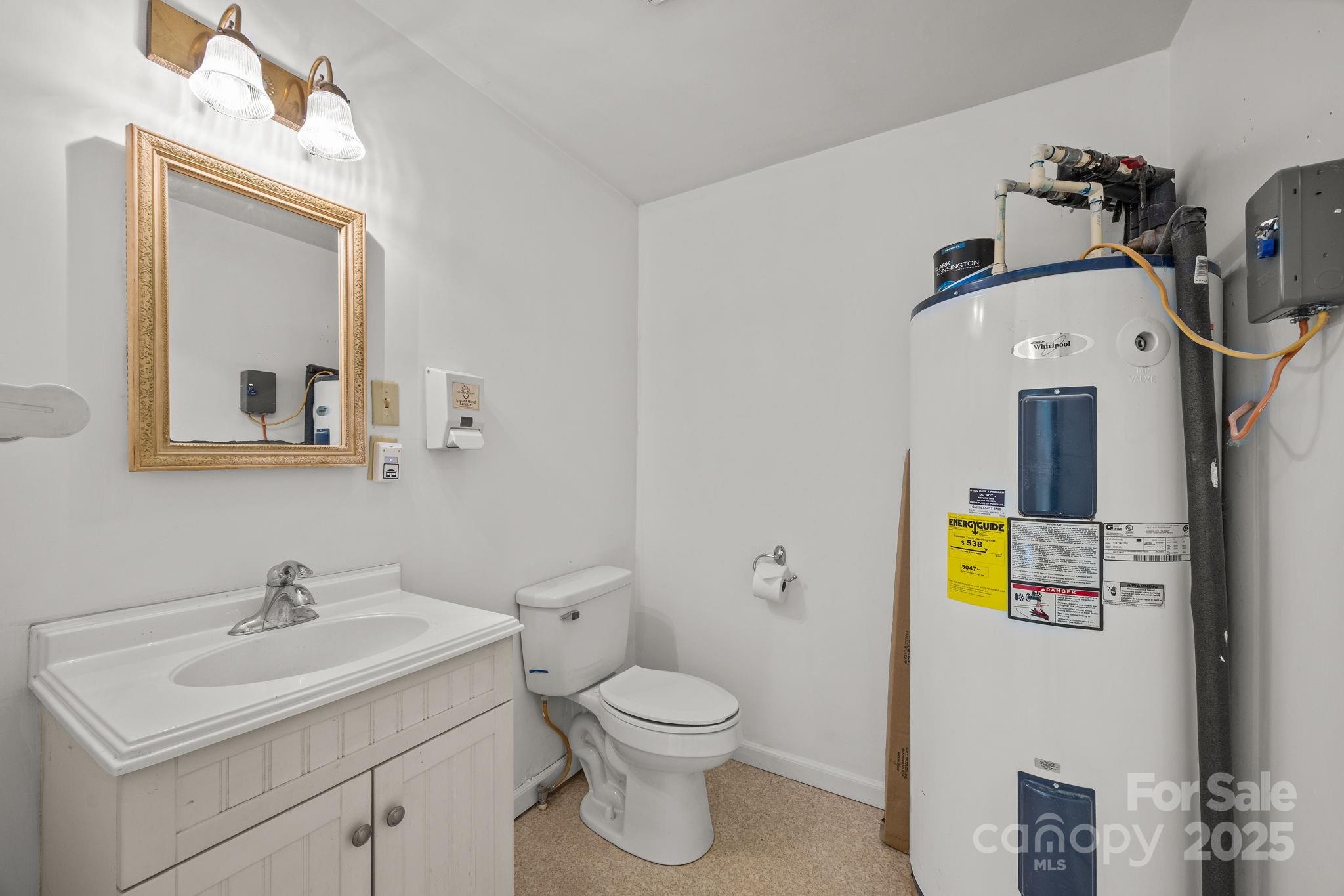 701 Dana Road Hendersonville, NC 28792 - Photo 27 of 27 a bathroom with a toilet sink and mirror