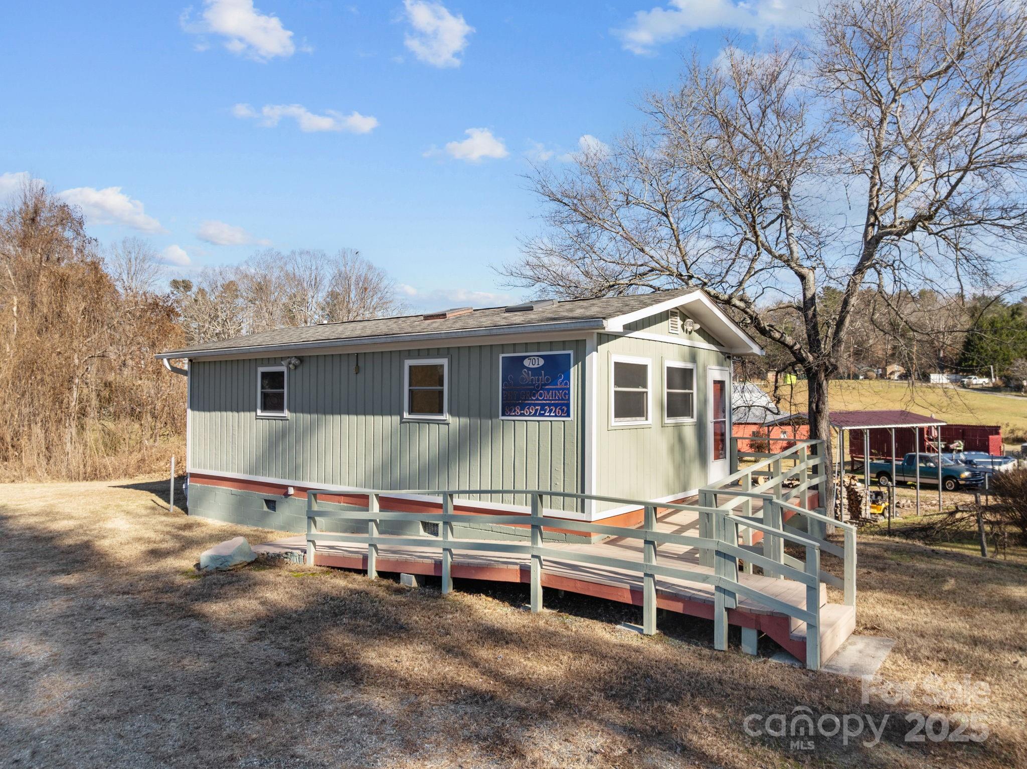 701 Dana Road Hendersonville, NC 28792 - Photo 3 of 27 an arial view of a house with wooden fence