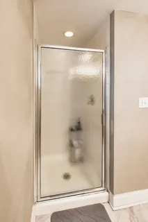a bathroom with a glass shower door
