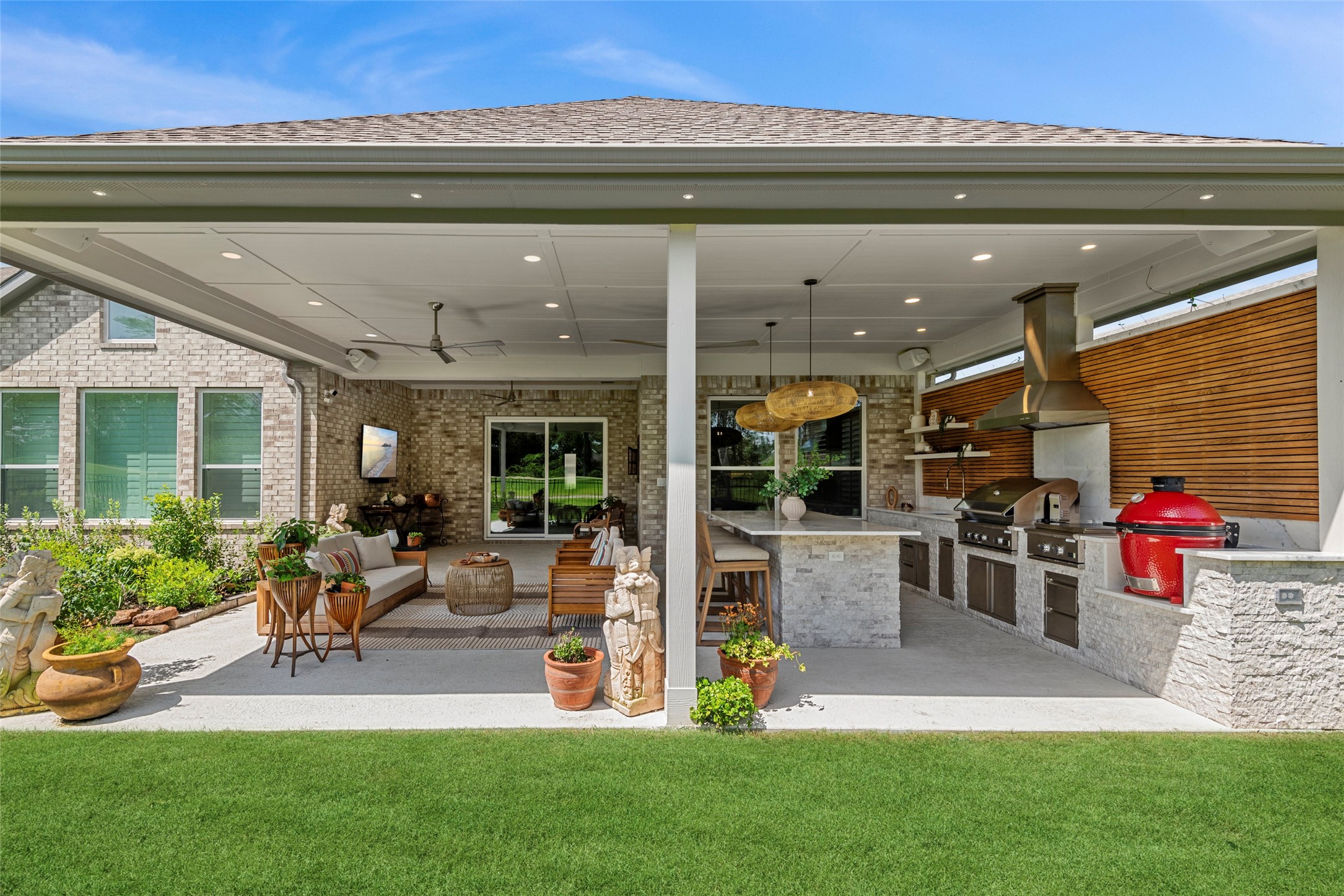 7519 Congress Trl Way Porter, TX 77365 - Photo 33 of 44 a view of a patio with table and chairs potted plants and floor to ceiling window