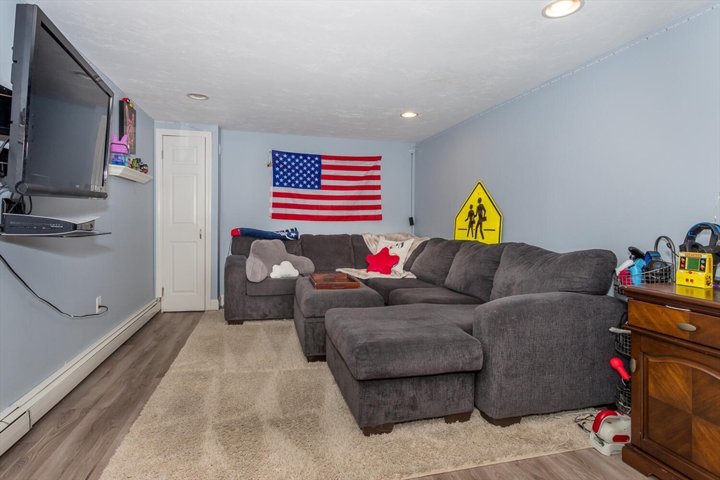 74 Cedarcrest Road Canton, MA 02021 - Photo 23 of 28 a living room with furniture and a flat screen tv