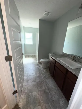 a bathroom with a sink a toilet a tub and shower