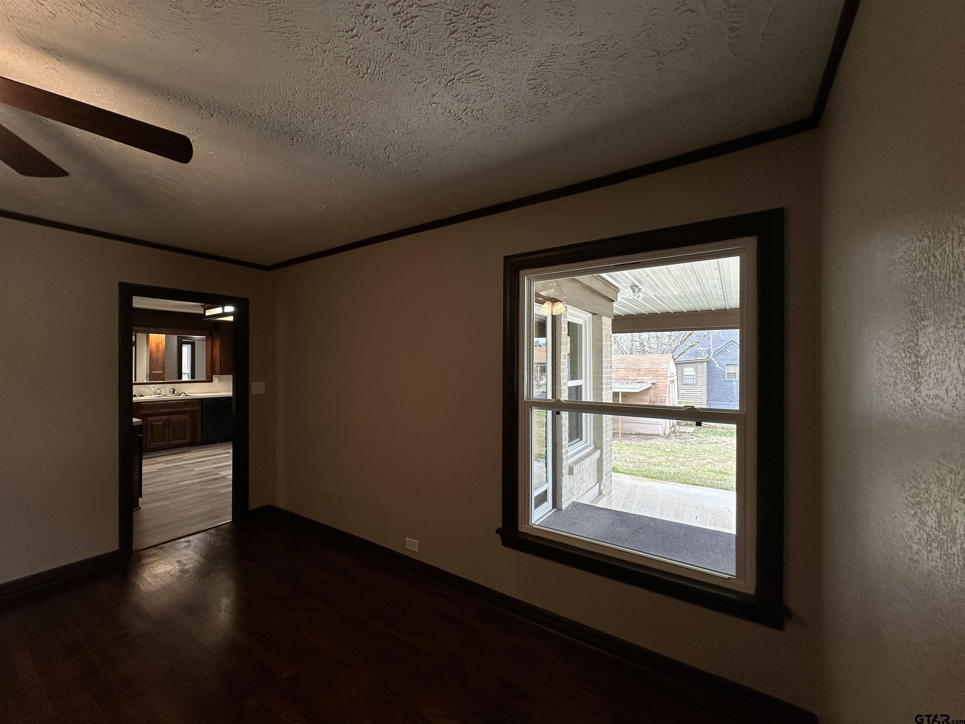 1118 East Main Street Atlanta, TX 75551 - Photo 26 of 34 a view of a hallway with wooden floor and a window