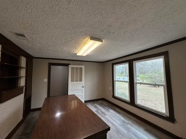 a view of hallway with wooden floor