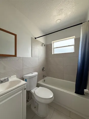 a bathroom with a toilet a sink and bathtub