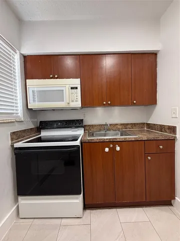 a stove top oven sitting inside of a kitchen