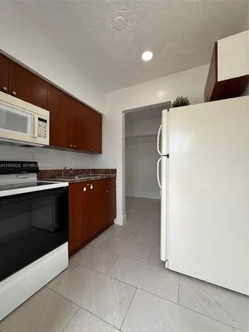 a kitchen with stainless steel appliances a refrigerator and a stove top oven