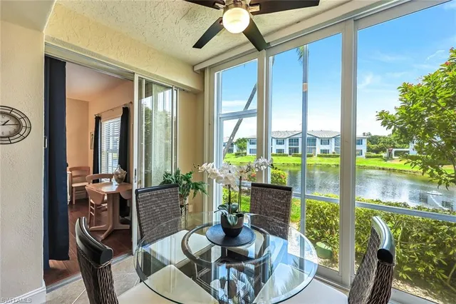 a dining room with furniture a chandelier and wooden floor