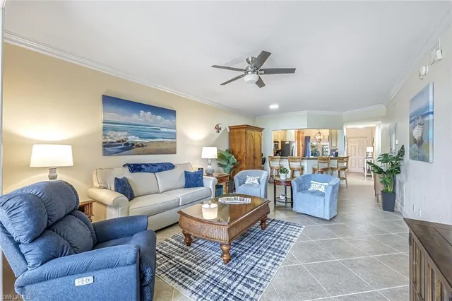 a living room with furniture a rug a lamp and a window