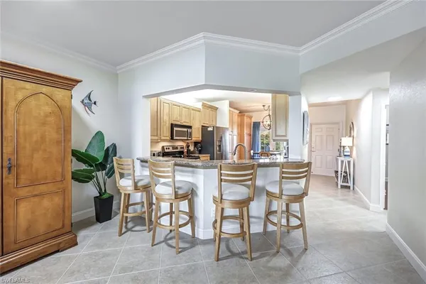 a dining room filled with furniture and a floor to ceiling window