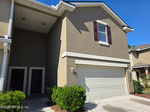 a front view of a house with a garage