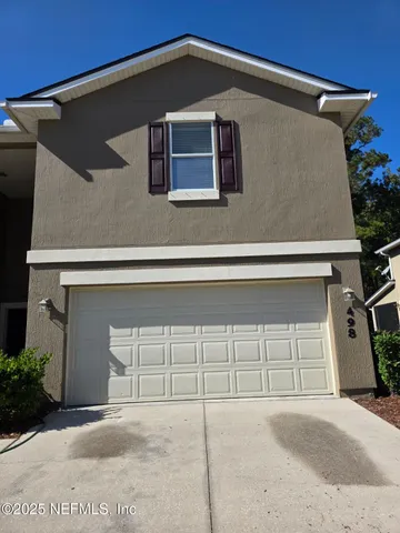 a front view of a house with a garage