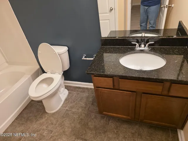 a bathroom with a toilet and a bathtub