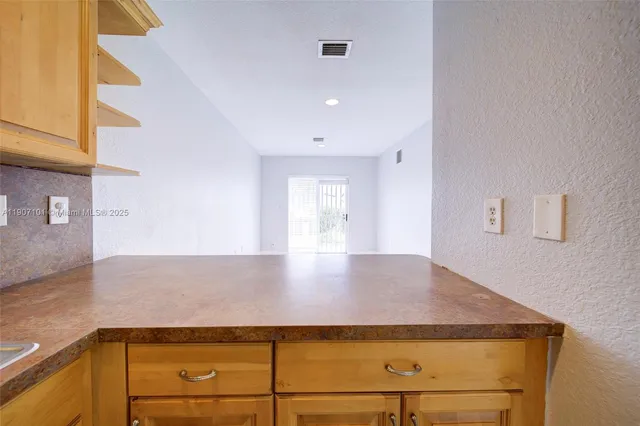 a view of kitchen and wooden floor