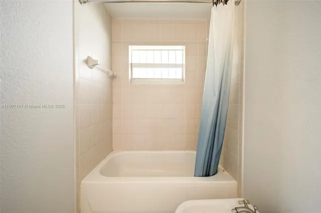 a bathroom with a bathtub and window