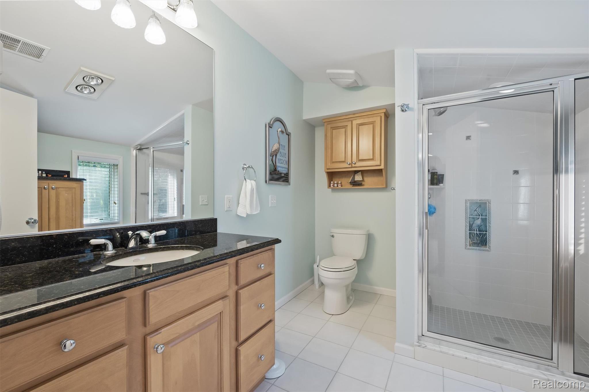 5892 Port Austin Road Caseville, MI 48725 - Photo 26 of 42 Bathroom featuring vanity, light tile patterned floors, and a stall shower