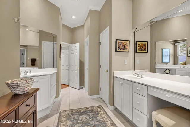 a spacious bathroom with a sink a mirror and a shower