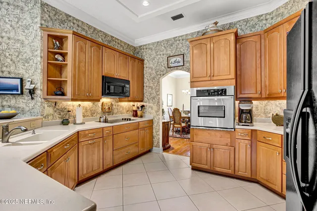 a kitchen with a sink window and cabinets