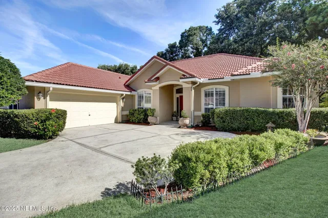 a front view of a house with a yard and garage