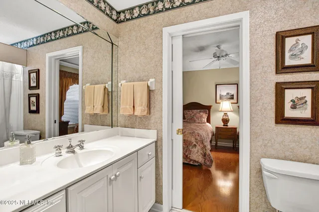 a en suite bathroom with a toilet sink and mirror
