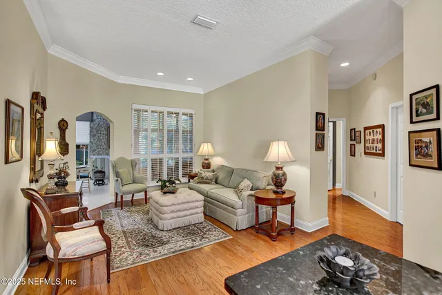 a living room with furniture and a lamp