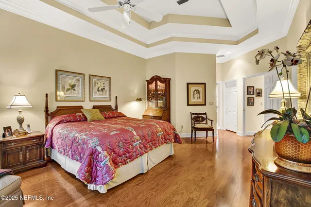 a bedroom with bed and a chandelier
