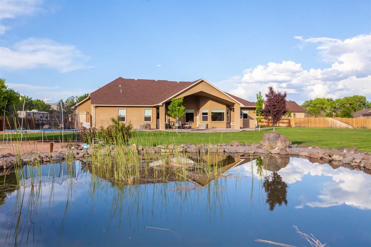 777 Foxtail Road Grand Junction, CO 81505 - Photo 26 of 26 a view of a house with yard and lake view