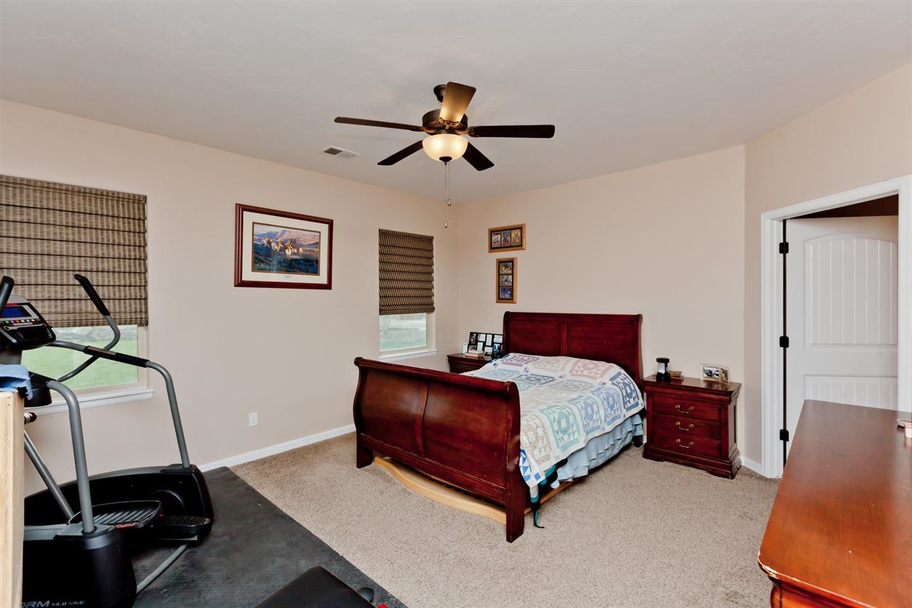 777 Foxtail Road Grand Junction, CO 81505 - Photo 8 of 26 a bed room with a bed window and a chair
