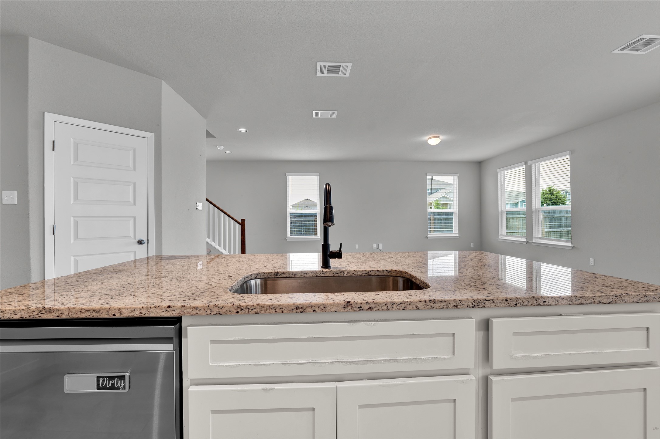 101 Crescent Street Georgetown, TX 78626 - Photo 10 of 39 Kitchen island with granite counters and a built-in sink provides the perfect gathering spot.