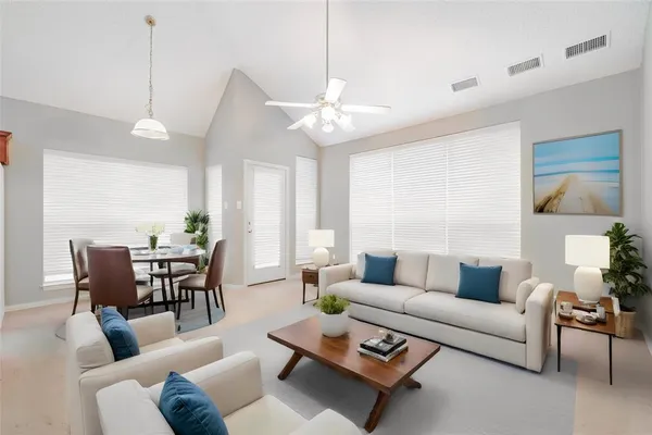 a living room with furniture a rug and a chandelier