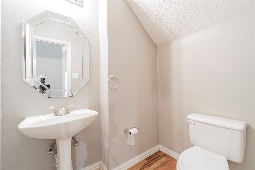 112 Midcrest Drive Irving, TX 75063 - Photo 13 of 37 a bathroom with a toilet sink and mirror