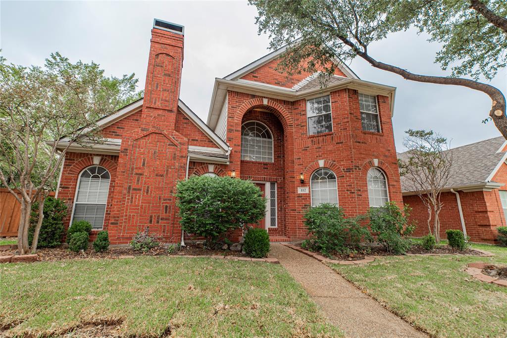 112 Midcrest Drive Irving, TX 75063 - Photo 2 of 37 a front view of a house with a garden