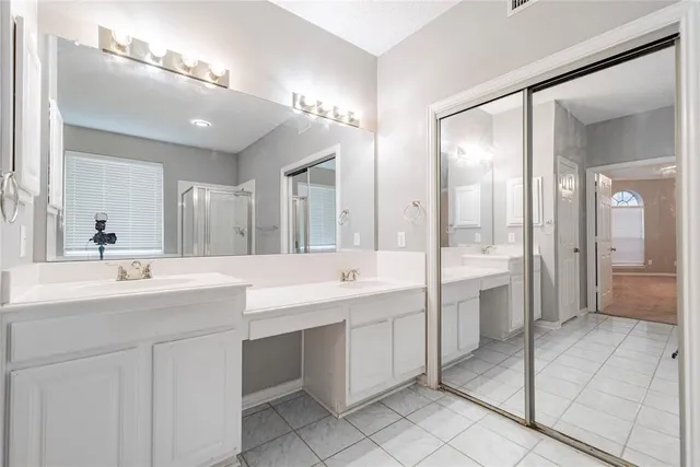 a bathroom with a double vanity sink mirror and double