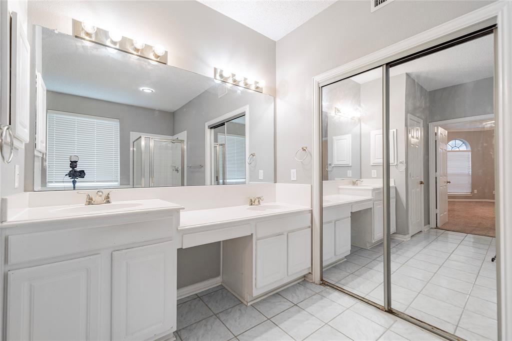 112 Midcrest Drive Irving, TX 75063 - Photo 21 of 37 a bathroom with a double vanity sink mirror and double