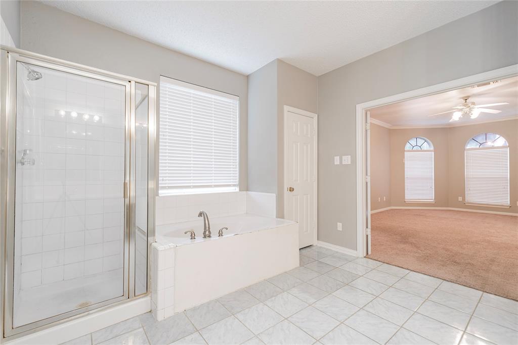 112 Midcrest Drive Irving, TX 75063 - Photo 22 of 37 a bathroom with a tub shower and sink