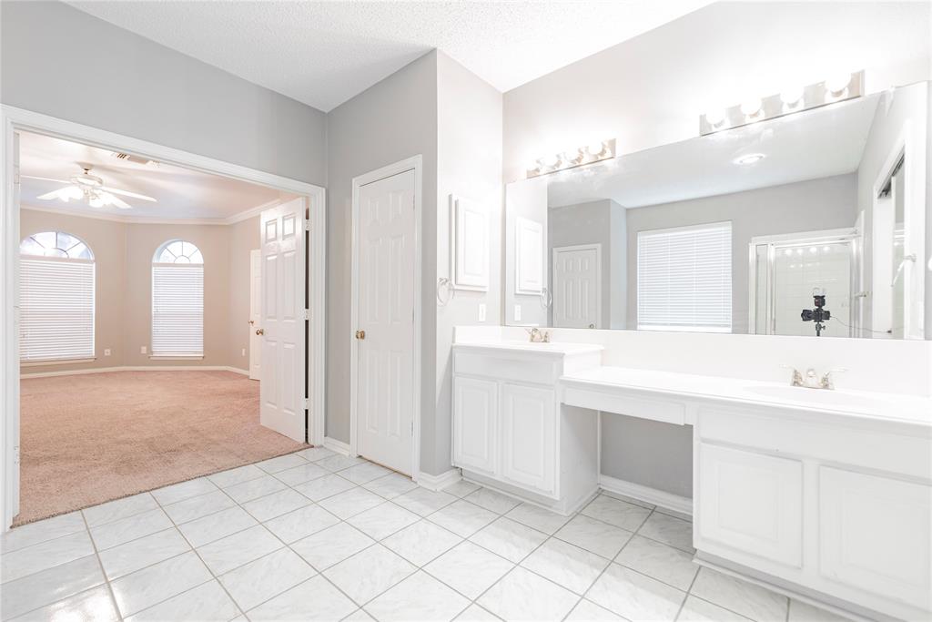 112 Midcrest Drive Irving, TX 75063 - Photo 23 of 37 a spacious bathroom with a shower a sink and a mirror