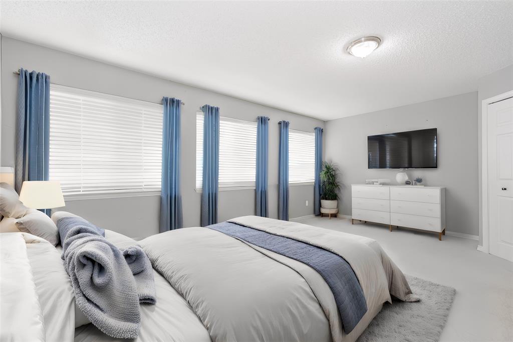 112 Midcrest Drive Irving, TX 75063 - Photo 27 of 37 a bedroom with a bed and a flat screen tv