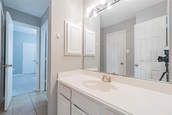a bathroom with a sink and a large mirror