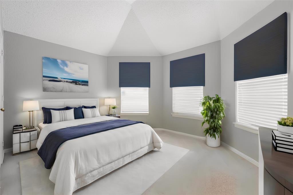 112 Midcrest Drive Irving, TX 75063 - Photo 31 of 37 a bedroom with a large bed and a potted plant