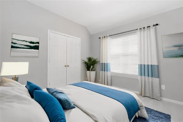 a bedroom with a bed and a window