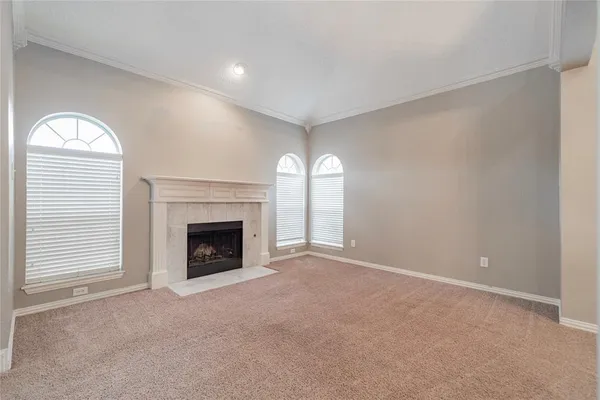 a view of a livingroom with a fireplace and window