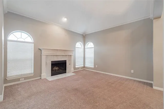a view of a livingroom with a fireplace and window