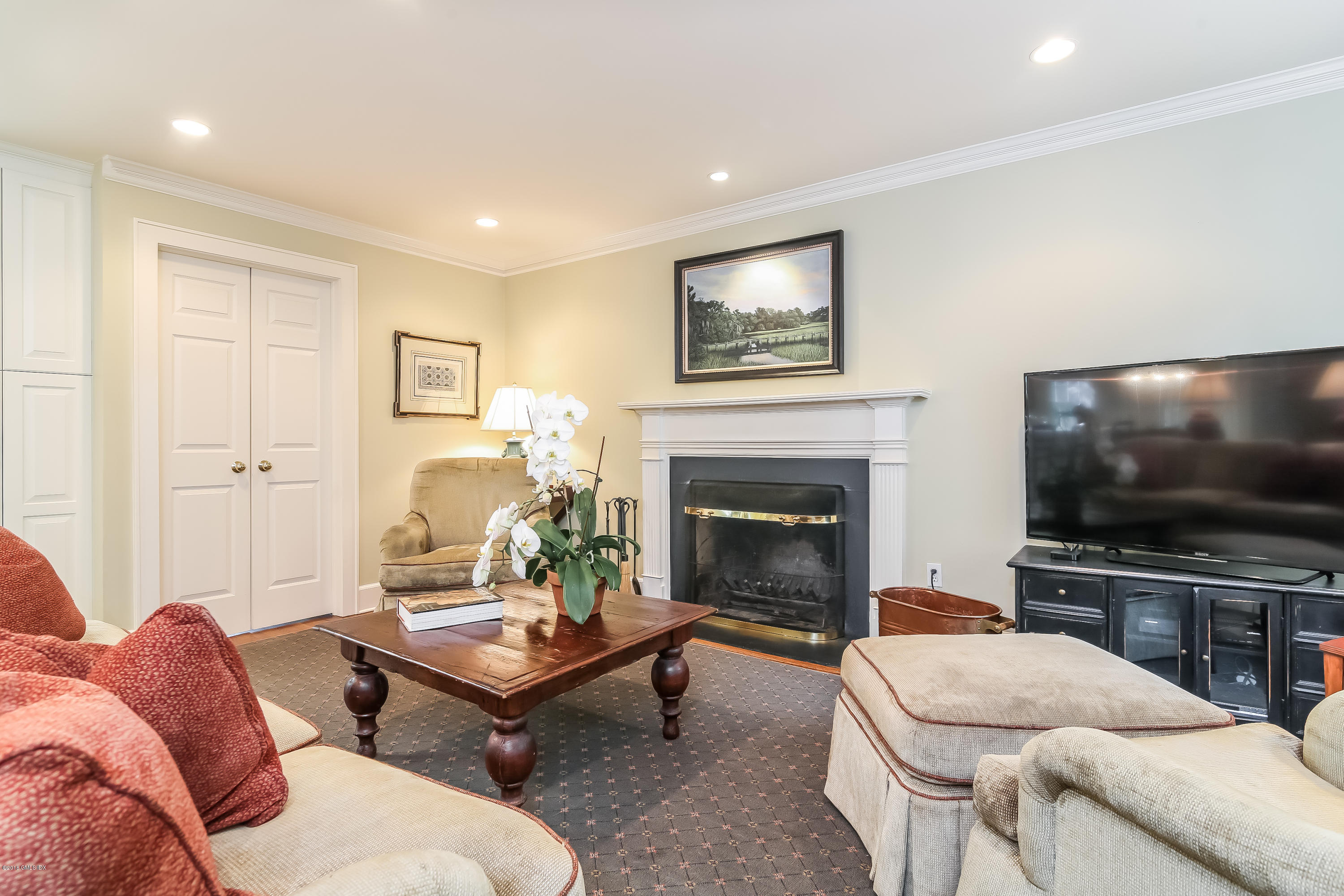 219 Riverside Avenue Riverside, CT 06878 - Photo 14 of 40 a living room with furniture a flat screen tv and a fireplace