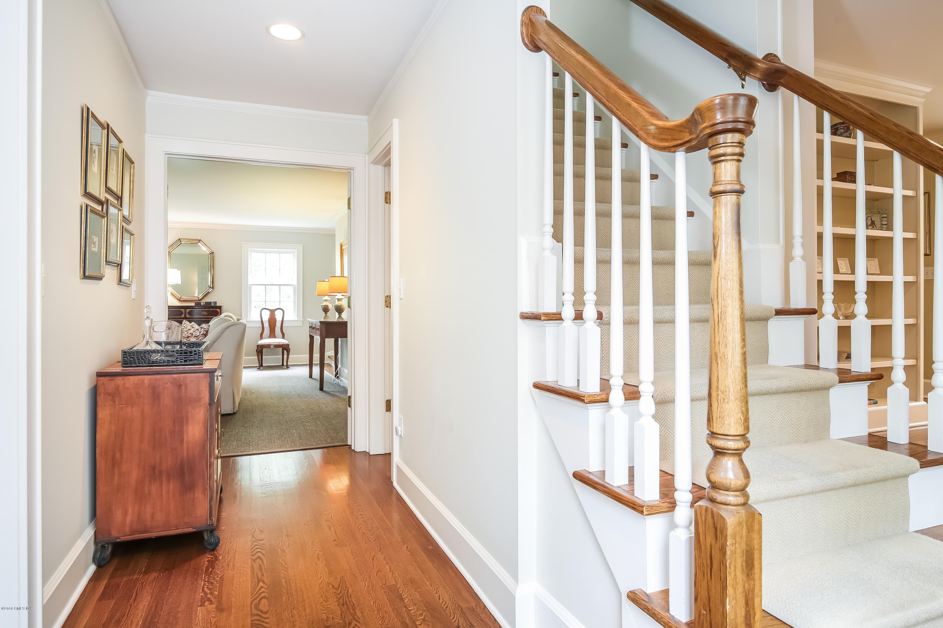 219 Riverside Avenue Riverside, CT 06878 - Photo 19 of 40 a view of a hallway with wooden floor and furniture