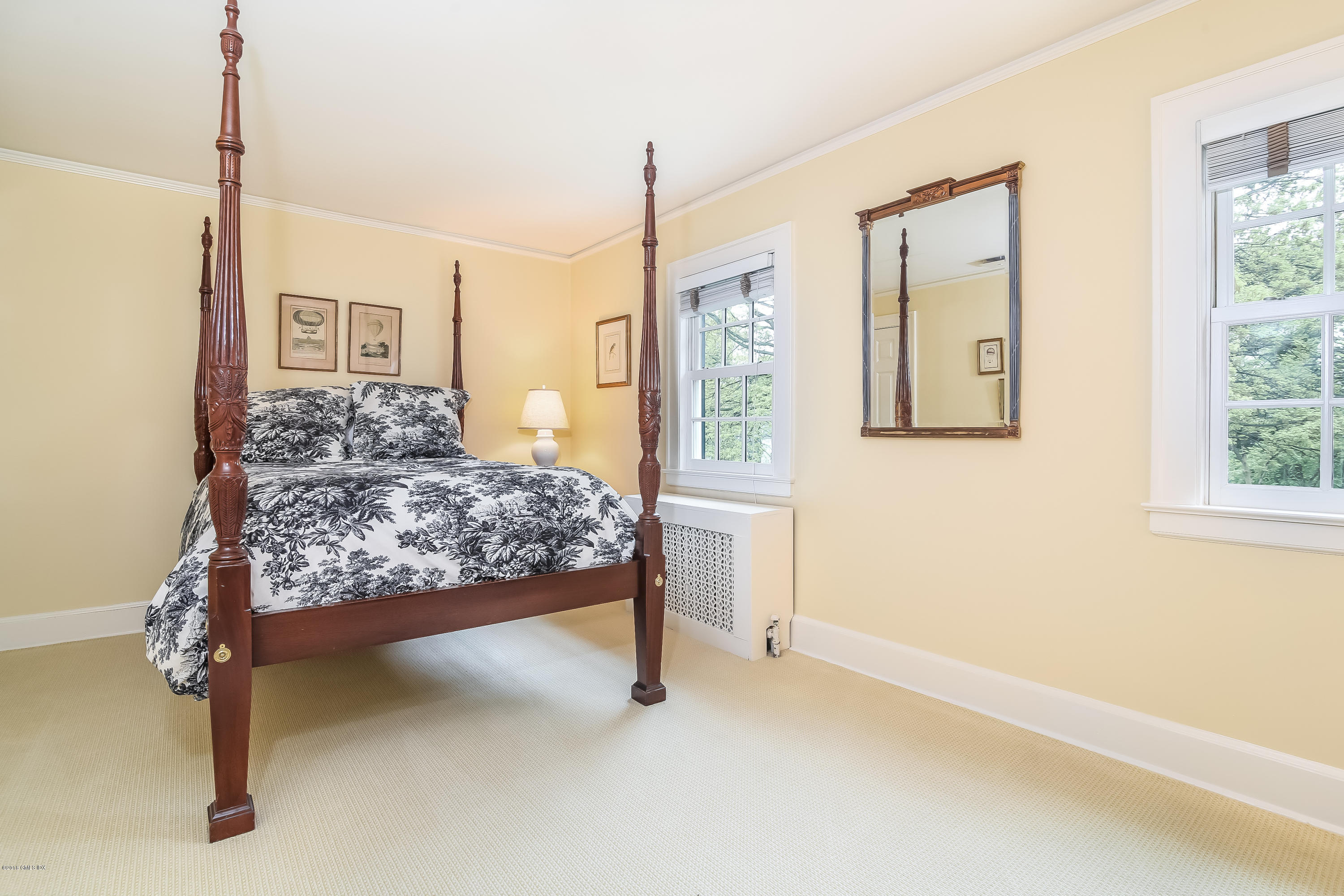 219 Riverside Avenue Riverside, CT 06878 - Photo 29 of 40 a bed sitting in a bedroom next to a window