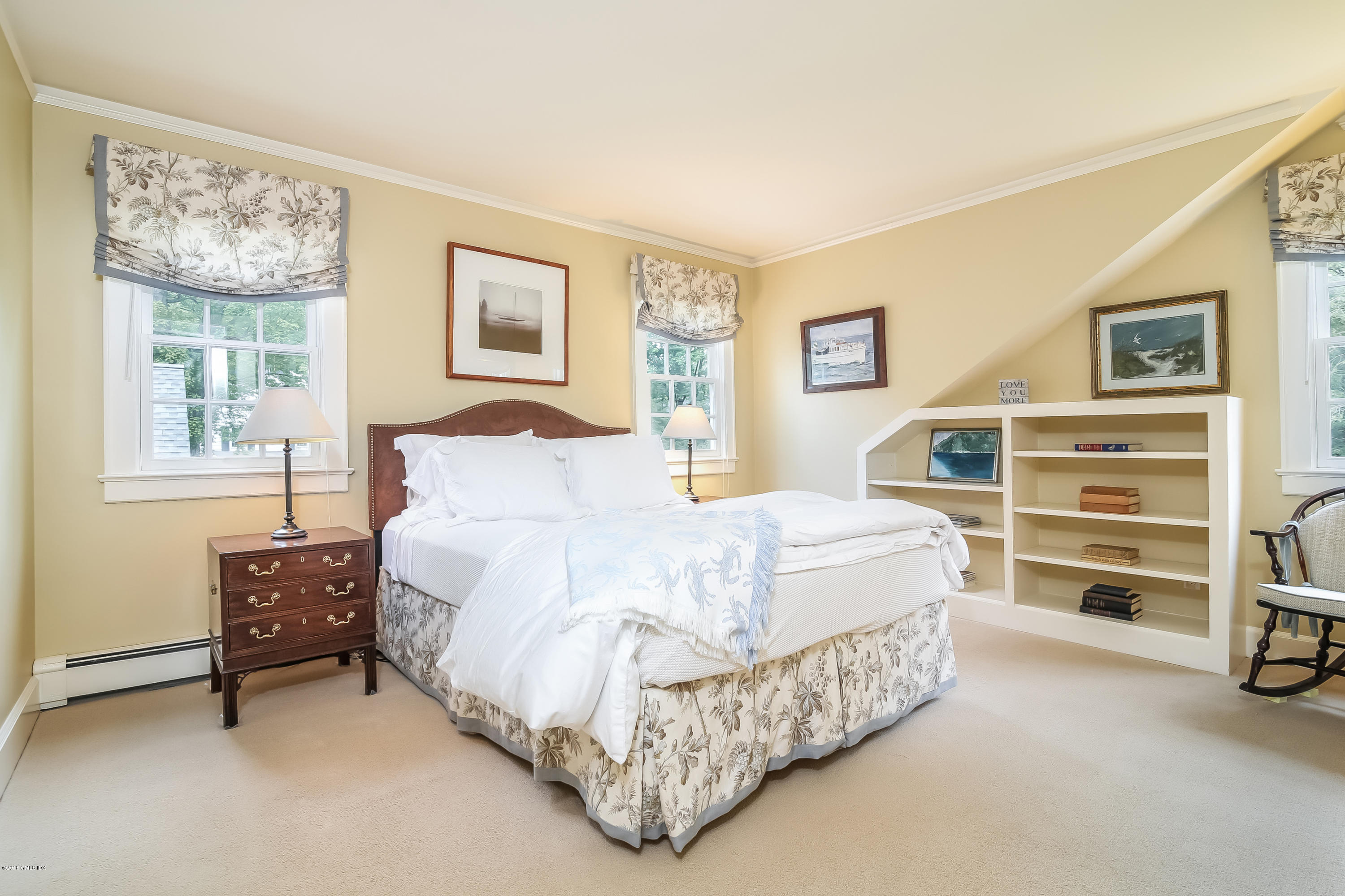 219 Riverside Avenue Riverside, CT 06878 - Photo 32 of 40 a bed sitting in a spacious bedroom next to a window with a dresser